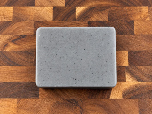 Hostile Takeover slate-grey triple butter soap on butcher block